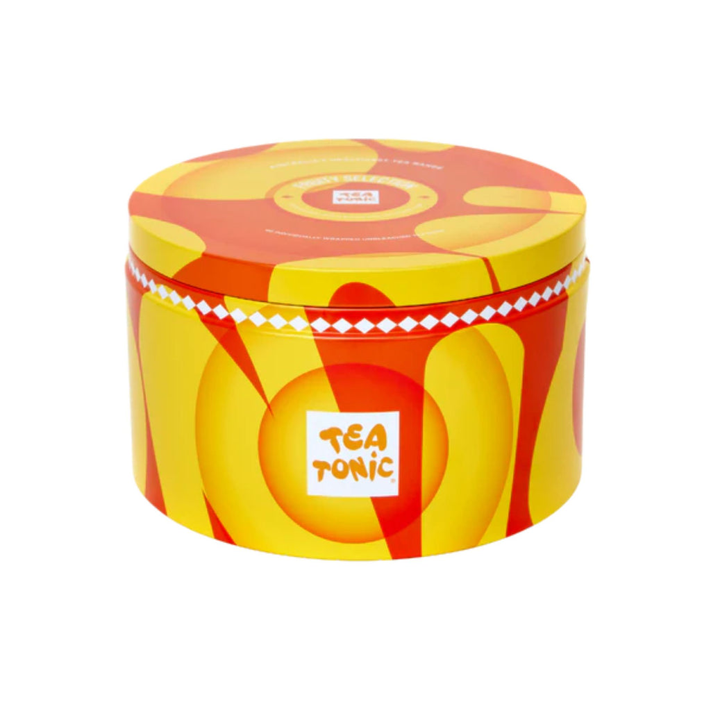 Tea tonic yellow tin containing fruity tea selection. Yellow and orange pattern