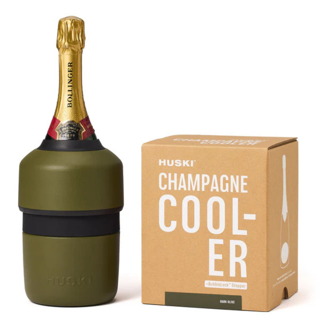 Champagne bottle with an olive green wine cooler on it. Next to the packaging box. Set against a white background