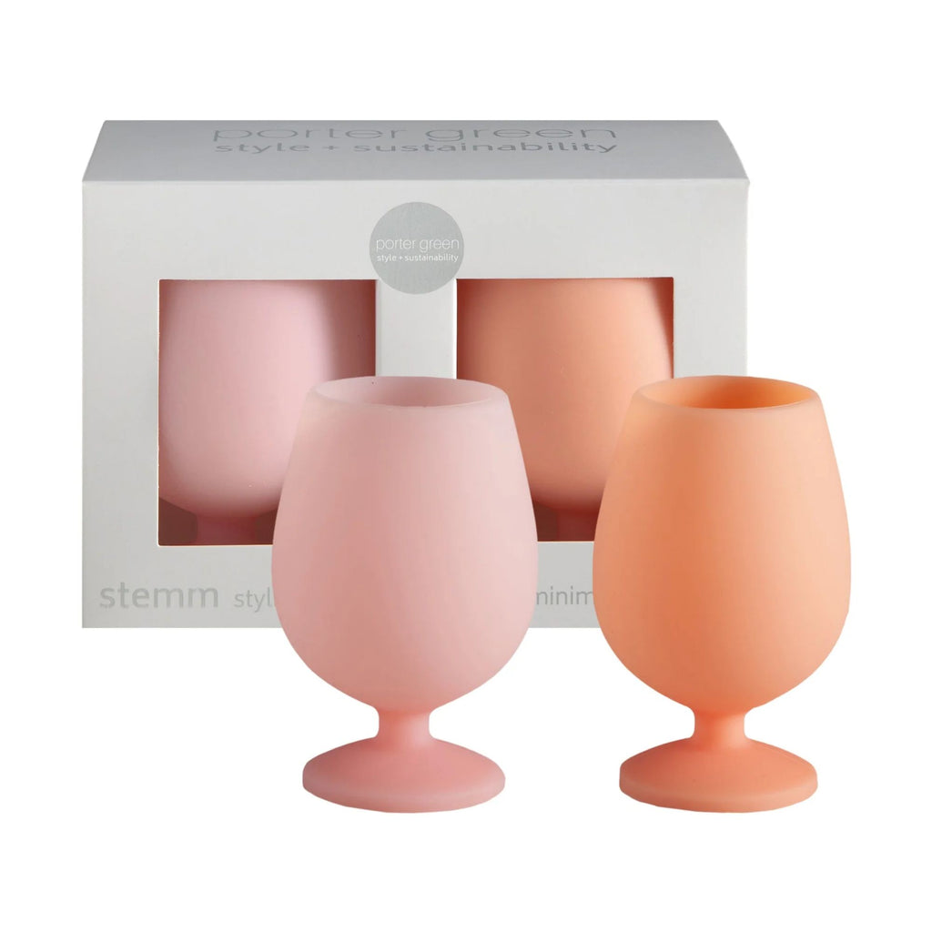 A set of Pink and orange silicone wine glasses in-front of a grey box filled with another set of Pink and orange wine glasses 