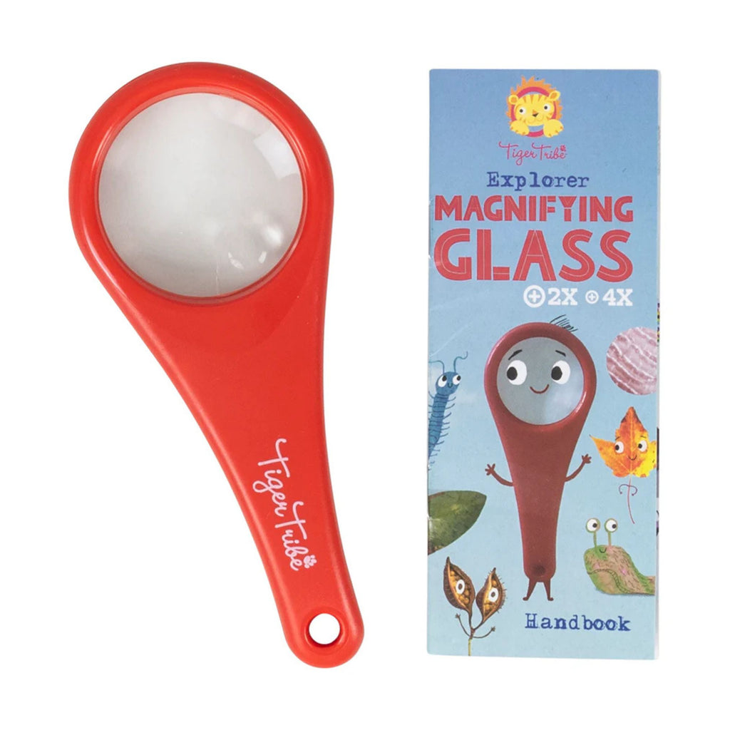 red toy magnifying glass for children. Next to packaging box with leaf illustrations. Set against a white background