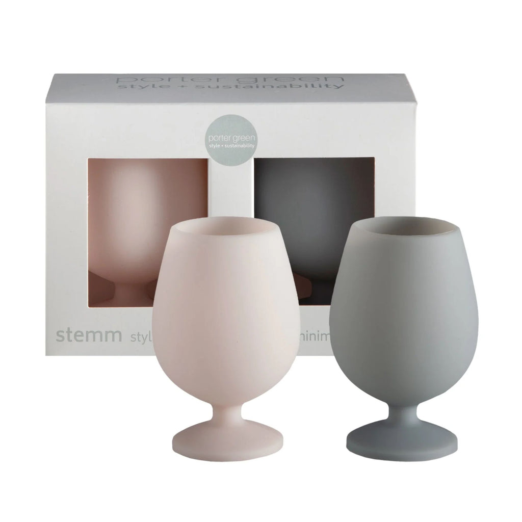 A grey box with set of two short silicone wine glasses in the colours cream and grey with the wine glasses presented in-front of the box 