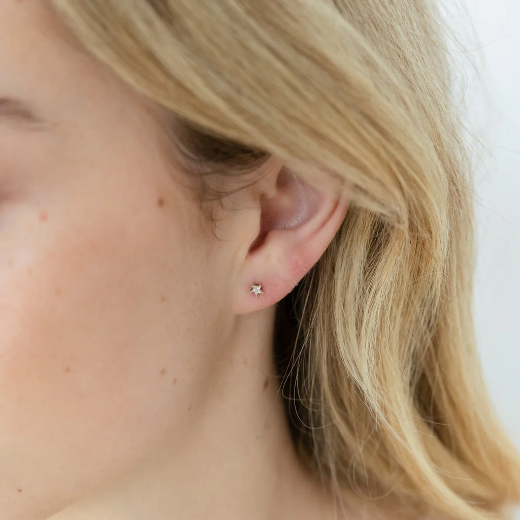 Girl wearing Silver studs with star shaped zirconia