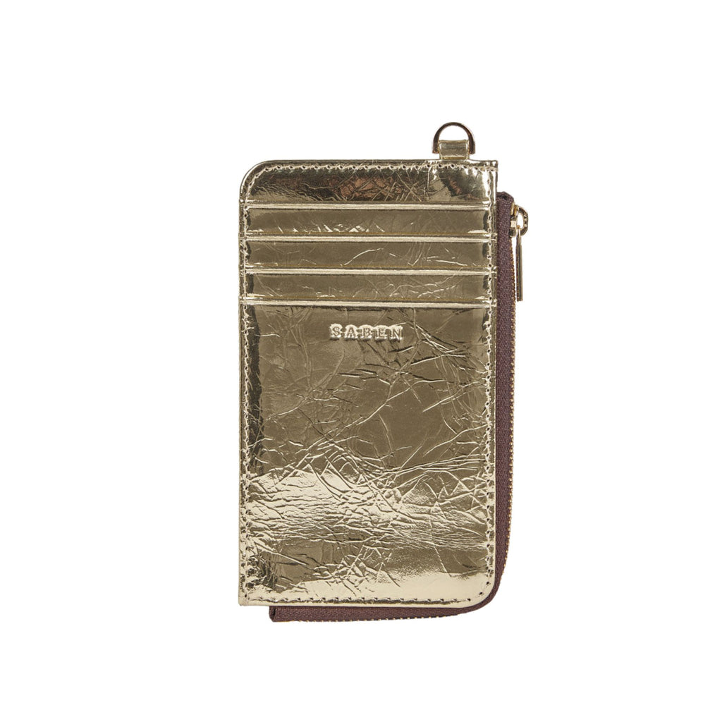 A white background with a gold foil rectangle leather card holder with D ring attached to the top, 4 card compartments and zip opening on the side.  Embossed SABEN branding on the front