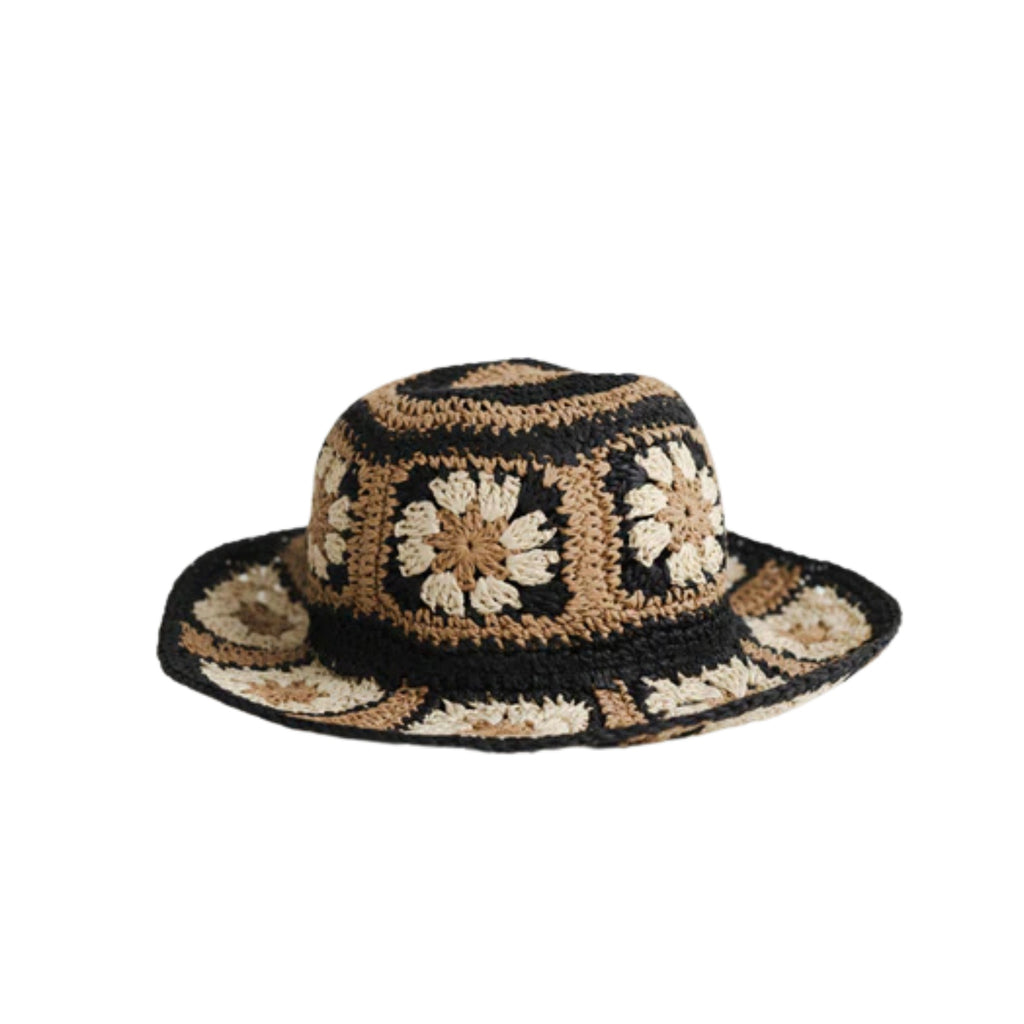 A white background with black, brown and white crochet bucket hat in a floral design.