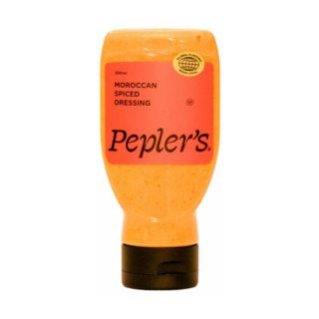 Peplers moroccan spiced dressing in an unside down clear plastic bottle with a black lid