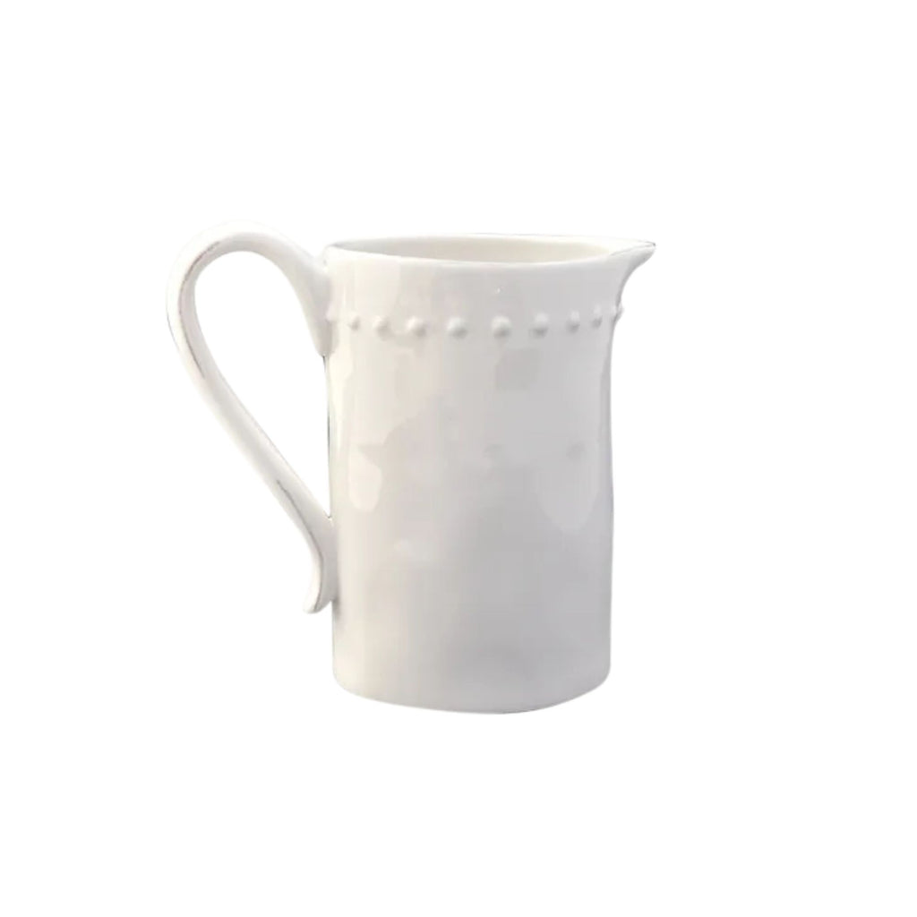 White ceramic jug with large handle and dotty detail around the top