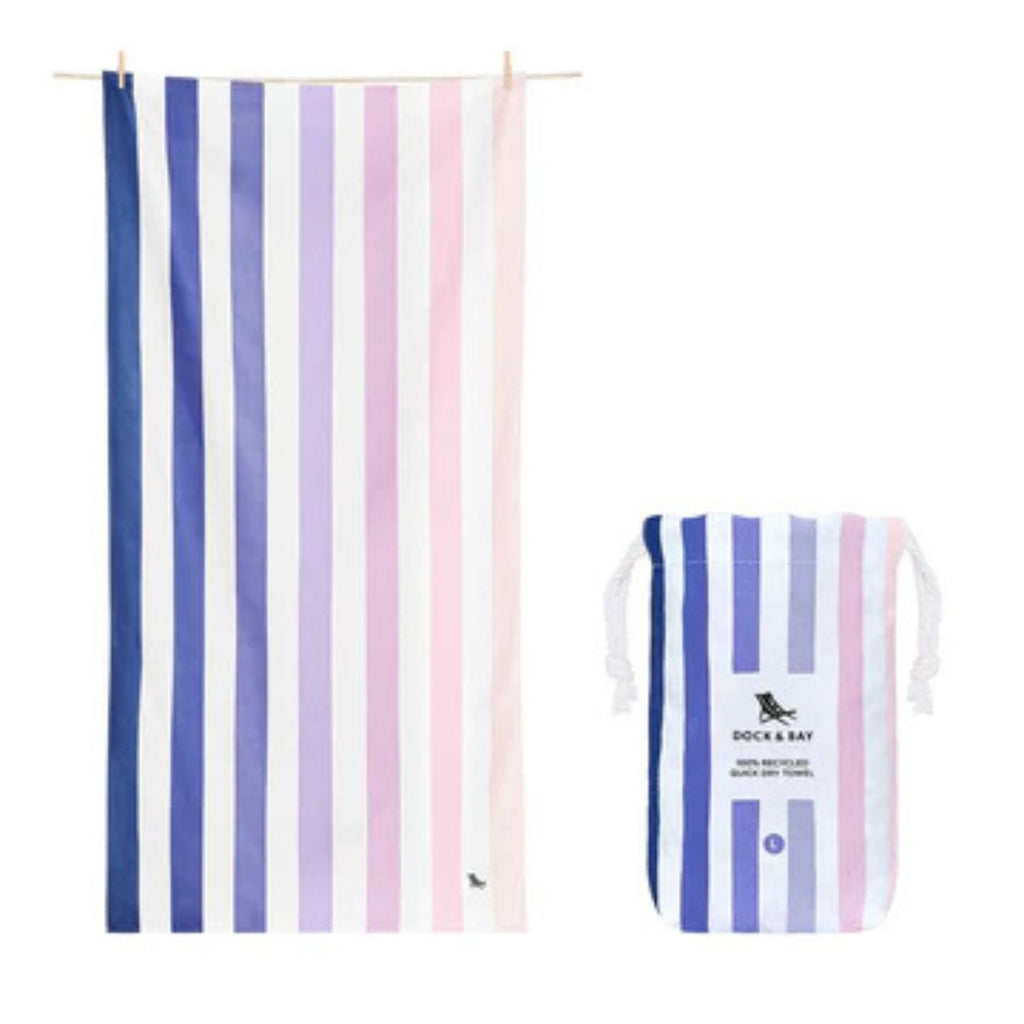 Beach towel and carry bag in blue to pink gradient stripes against a white background