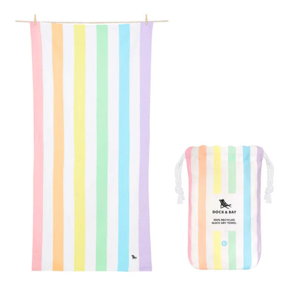 Beach towel and carry bag in pastel rainbow stripes against a white background