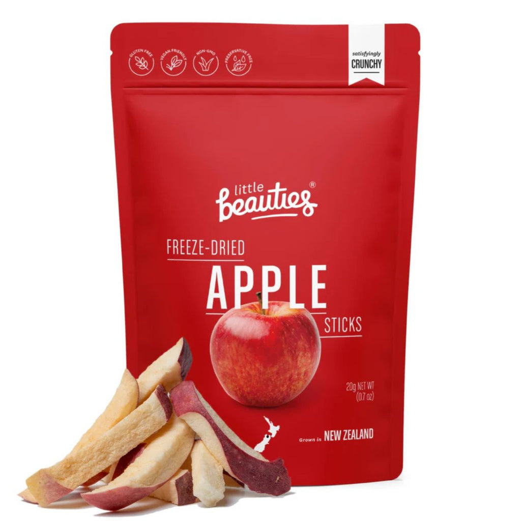 Red food pouch with branding printed and an apple. Dried apple sticks product to the left. Against a white background