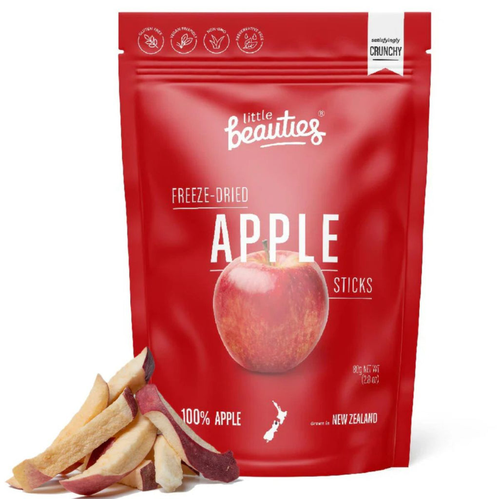 Red food pouch with branding printed and an apple. Dried apple sticks product to the left. Against a white background