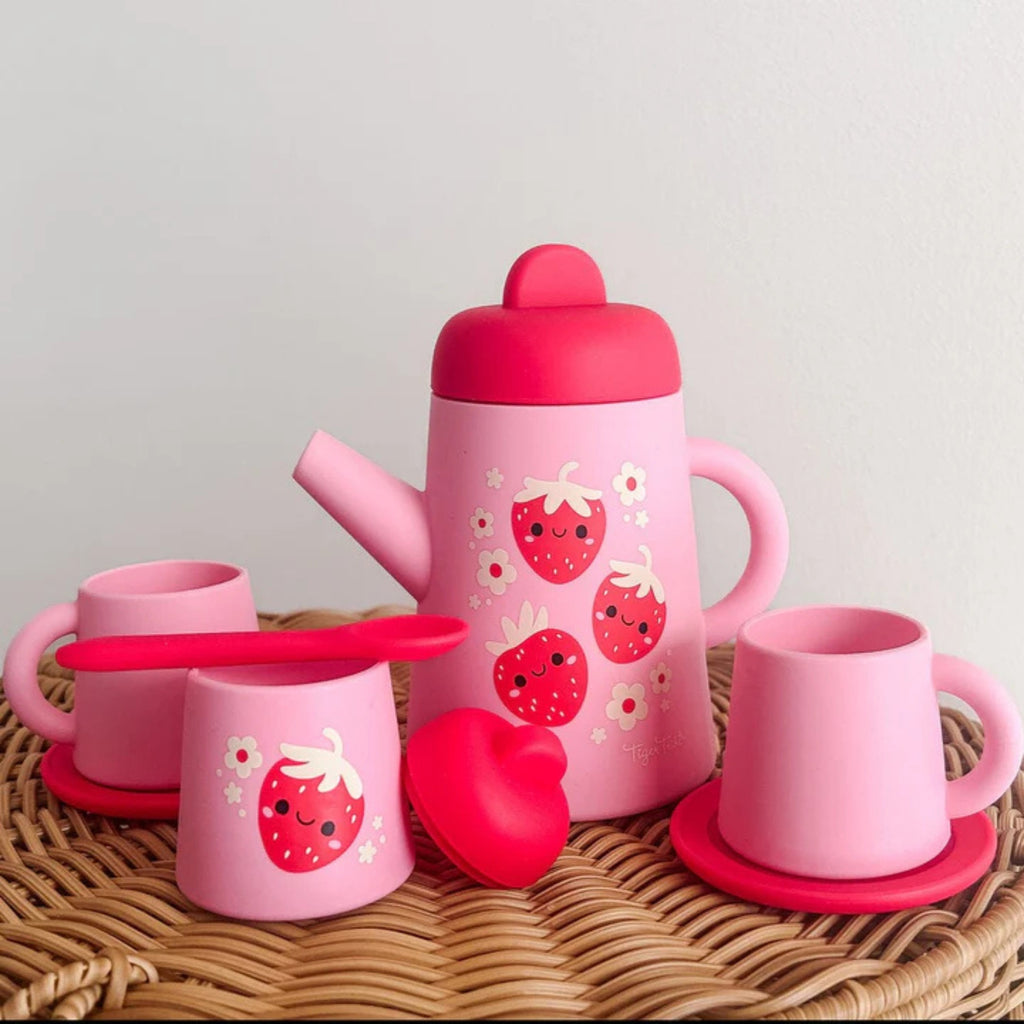 A light pink and hot pink children's silicone tea set with strawberry design on the front.