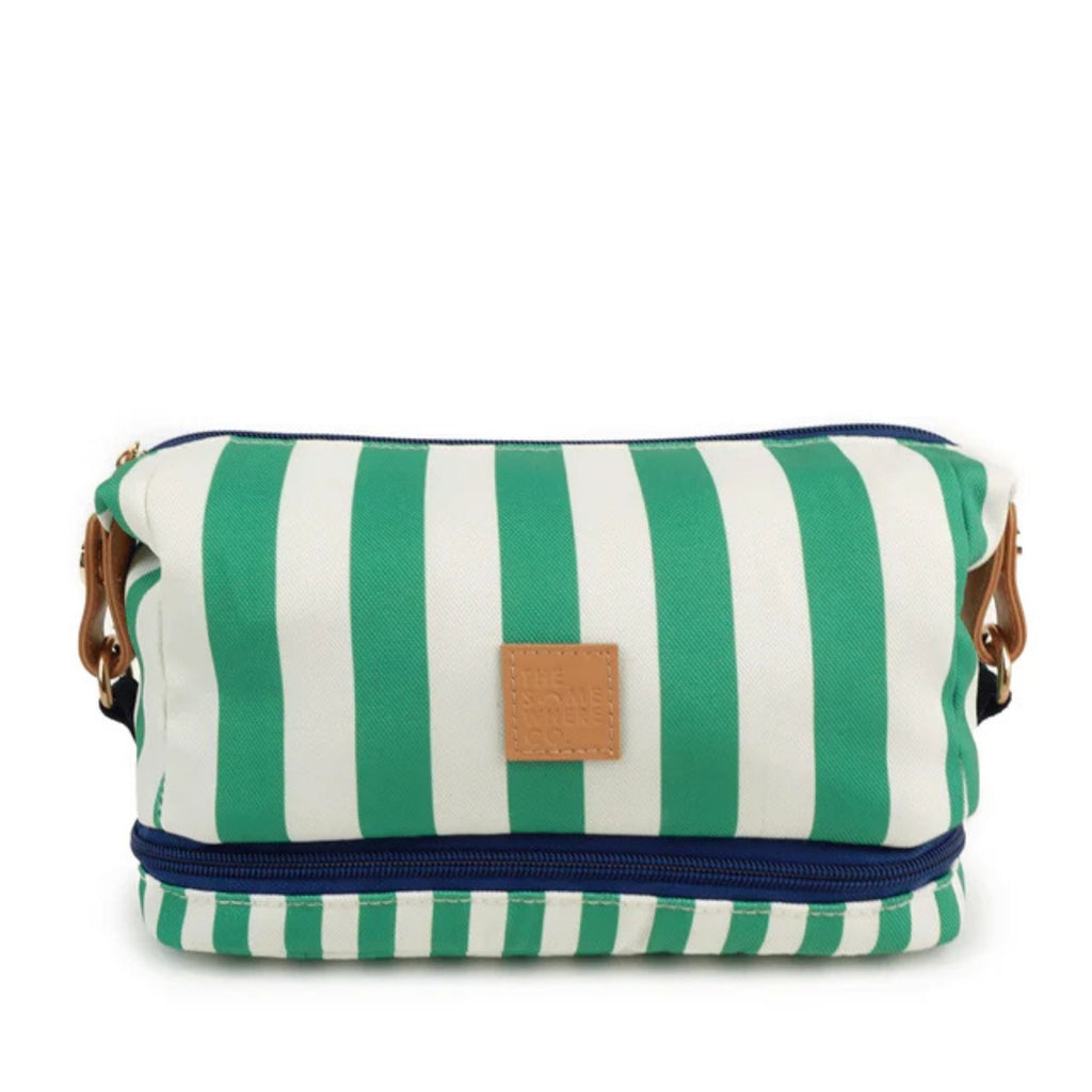 white background with a cosmetic case in foreground in green and white stripes and a navy zip