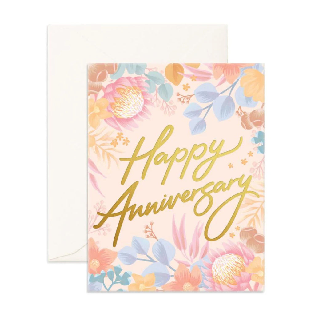 Beige greeting card with flowers reading "happy anniversary" in gold font and an envelope 