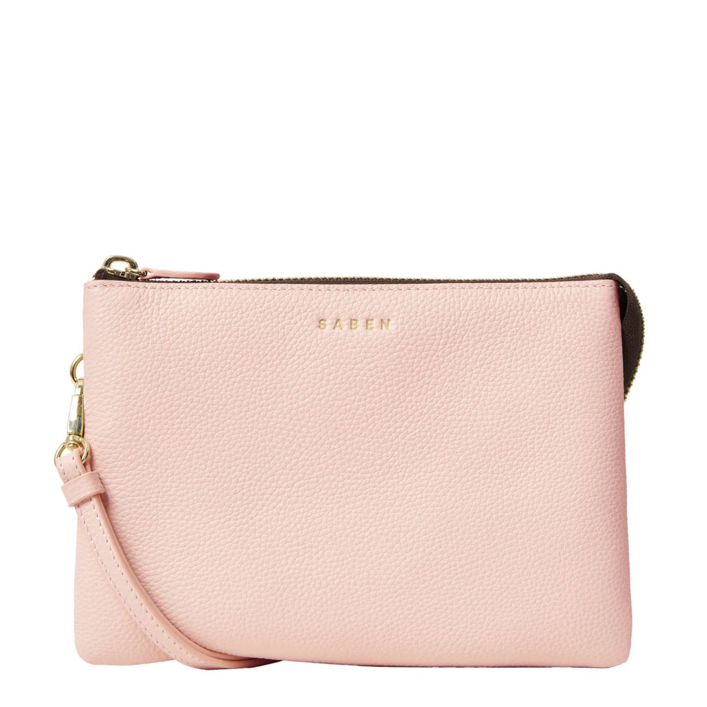 Blush pink leather handbag with thin shoulder strap against a white background