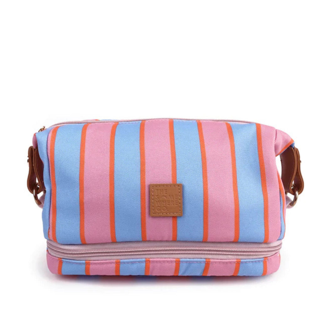 white background with cosmetic case in foreground. blue, pink and orange stripe with pink zipper