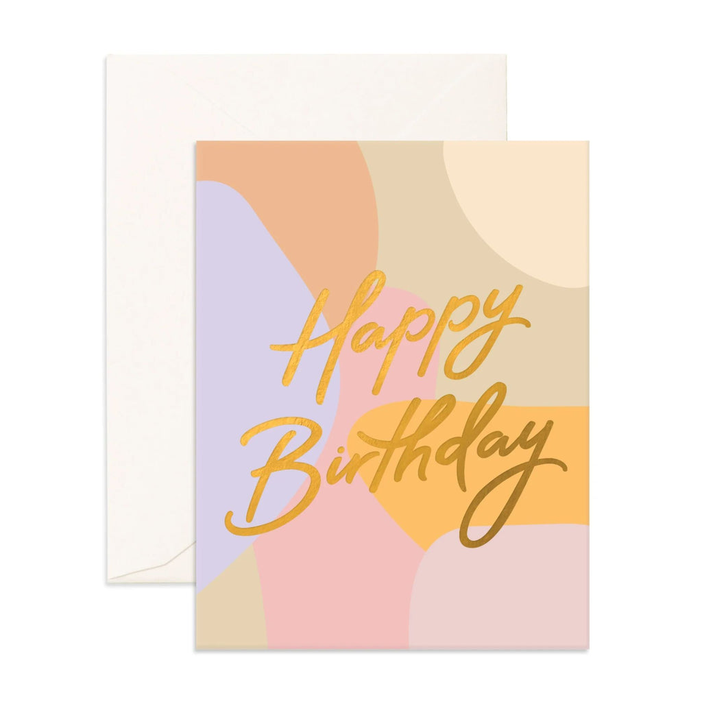 greeting card with multi-coloured blobs reading "happy birthday" in gold font with an envelope