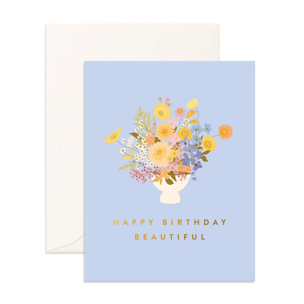 Light blue greeting card with flower vase reading "happy birthday beautiful" and an envelope