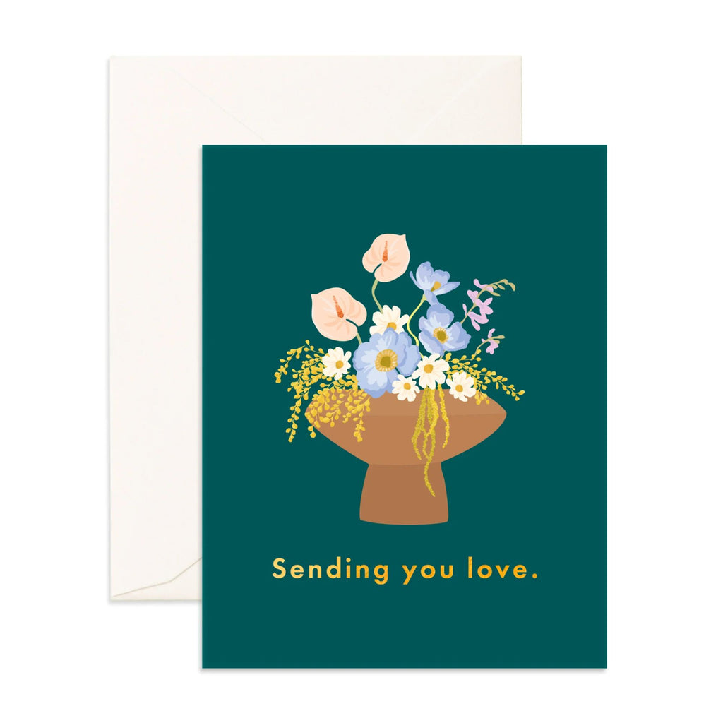 Dark blue greeting card with flowers reading "sending you love" in gold font with an evelope