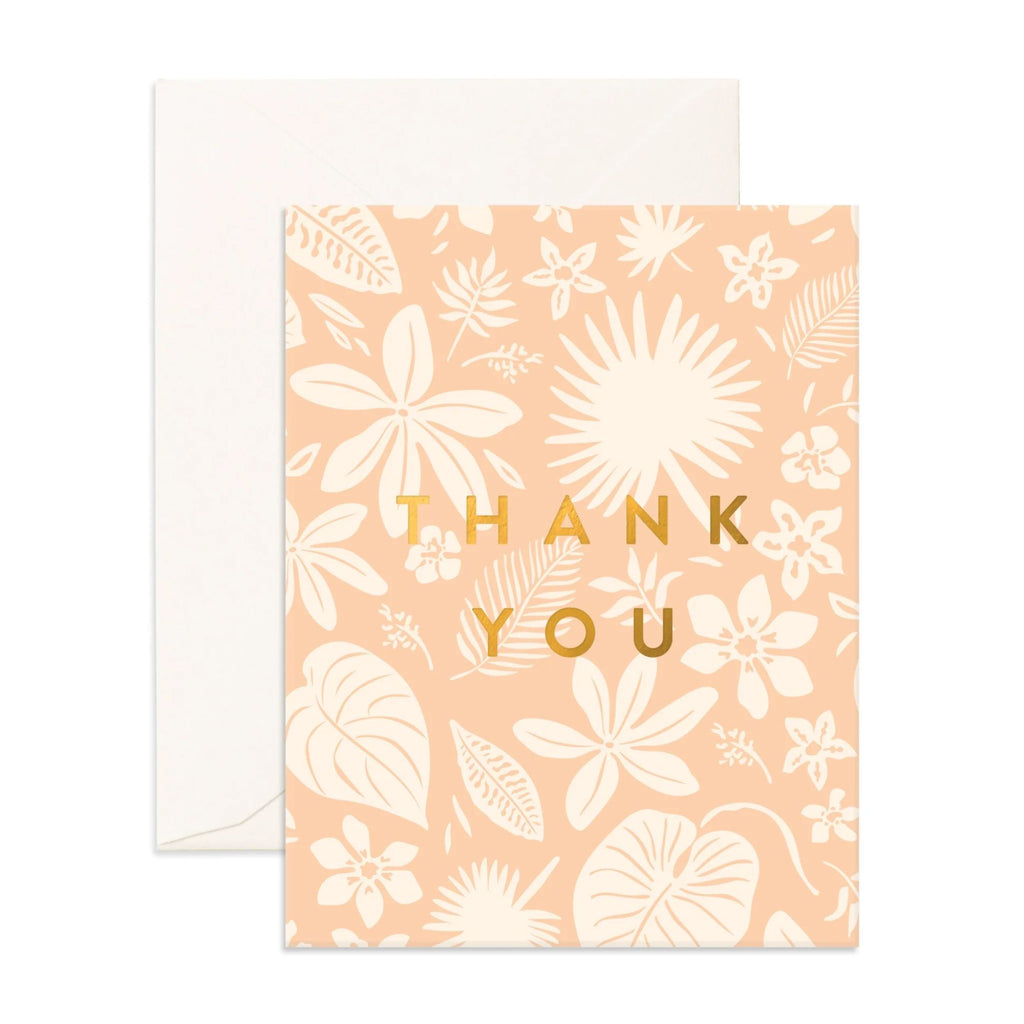 Light pink greeting card with a white flowers and foliage on it reading "Thank you" in gold text with an envelope