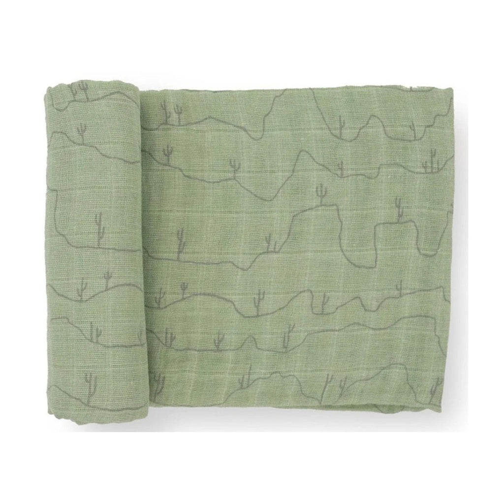 Muslin baby swaddle in green with cactus print. product against a white background