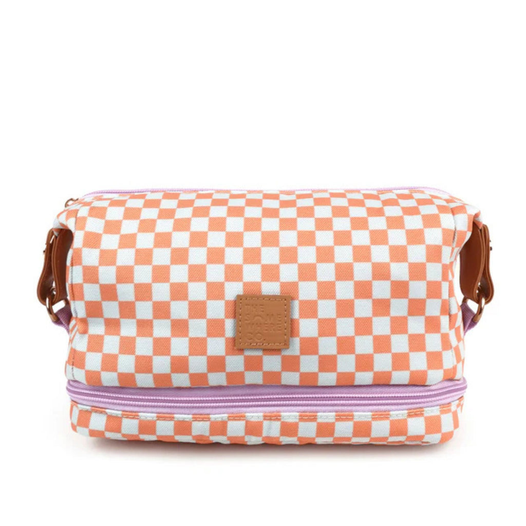 white background with orange and white checkered make up case in foreground. Purple zip