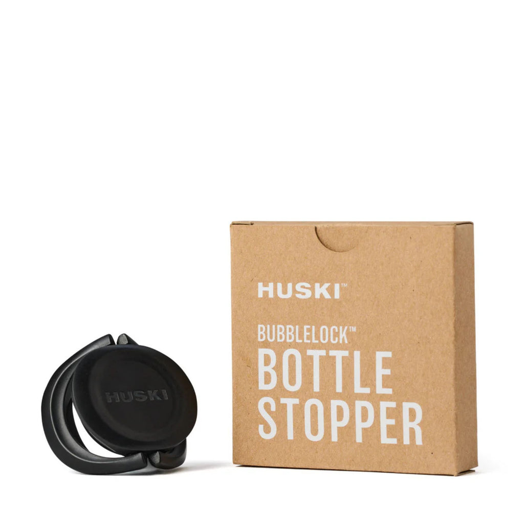 Black champagne stop and brown box labeled bottle stopper 