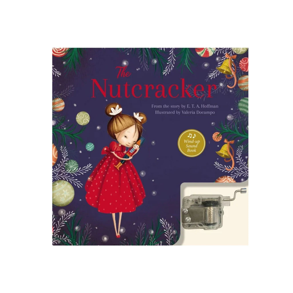 A blue picture book with a girl holding a nutcracker and Christmas decorations titled "the nutcracker" with a music box