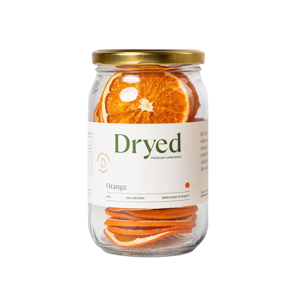 Dryed dehydrated orange slices in a clear glass jar with white label