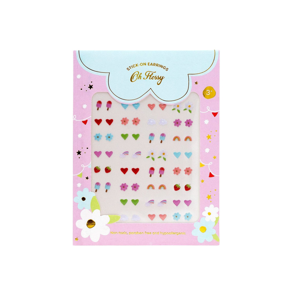 A sheet if various children's sicker earrings visible through a transparent sheet surrounded by pink packaging with flowered labelled "oh Flossy" with the subtitle "stick on earrings" 