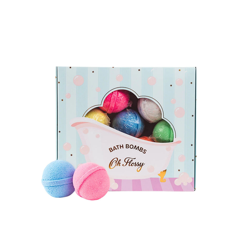 A blue box with a bathtub illustration and transparent window of various multicoloured bath-bombs and two bath bombs to the white against a white background labelled "oh flossy" and sub-titled "Bath Bombs"