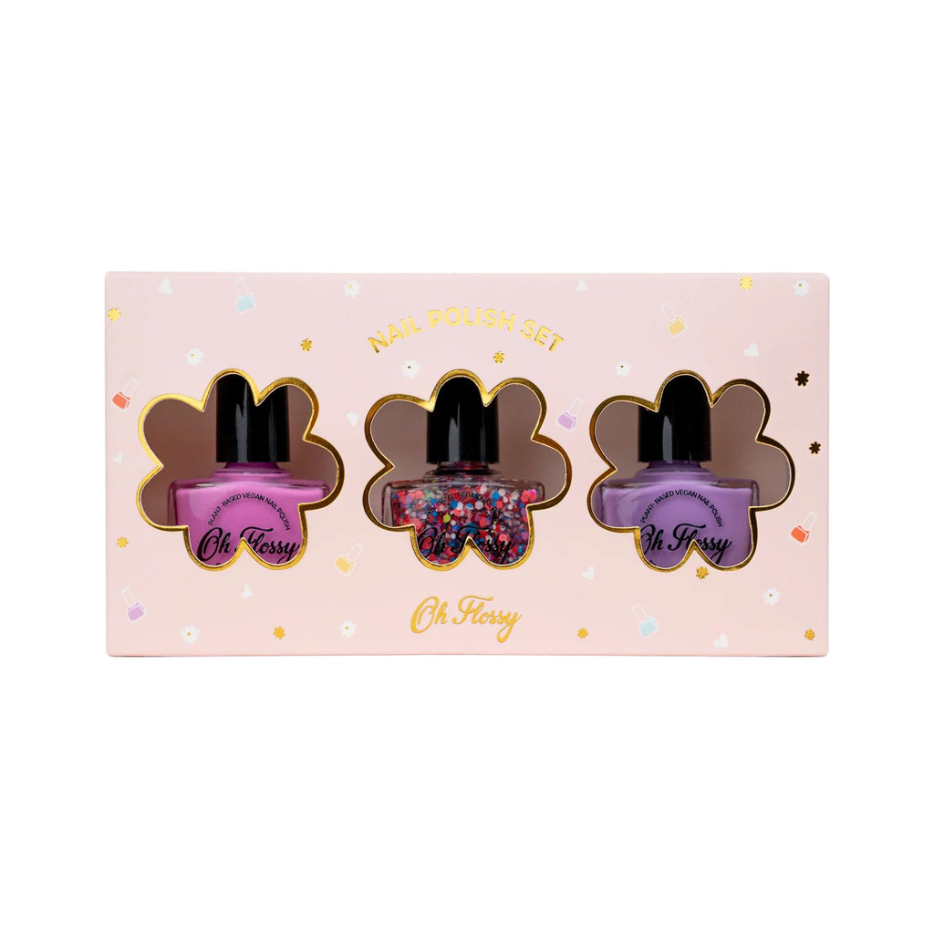 A pink box with a flower pattern featuring three flower cut outs with three different bottles of pink, rainbow glitter and purple nail Polish labelled "Nail polish set" and "Oh Flossy" 