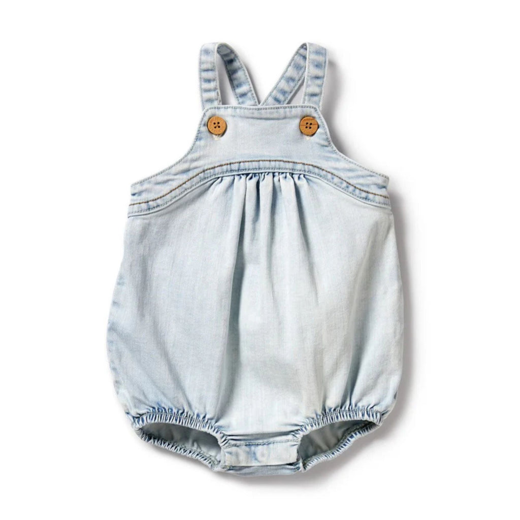 white background with a baby's denim bodysuit in the foreground