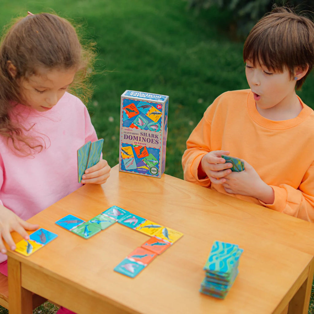 A girl and a boy playing a card game