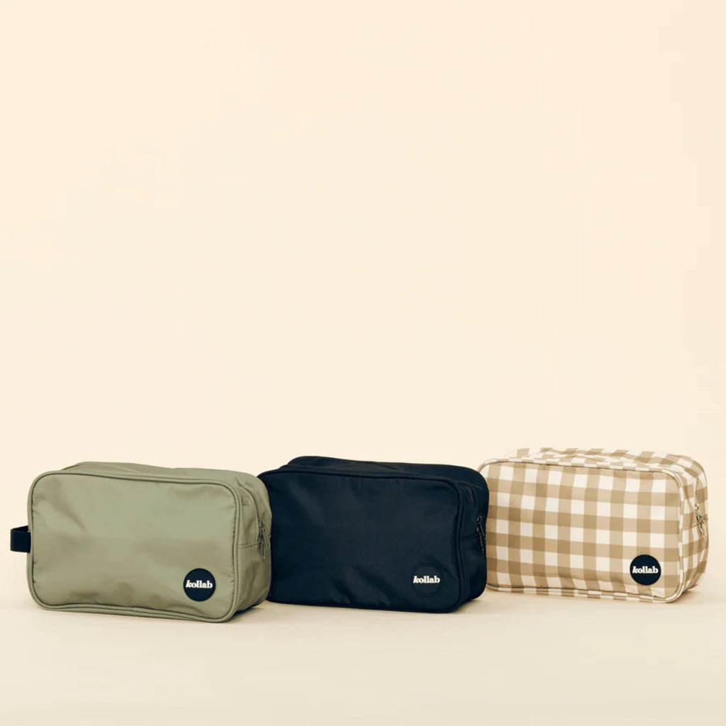 A set of three travel bags in khaki, black and white and brown check 