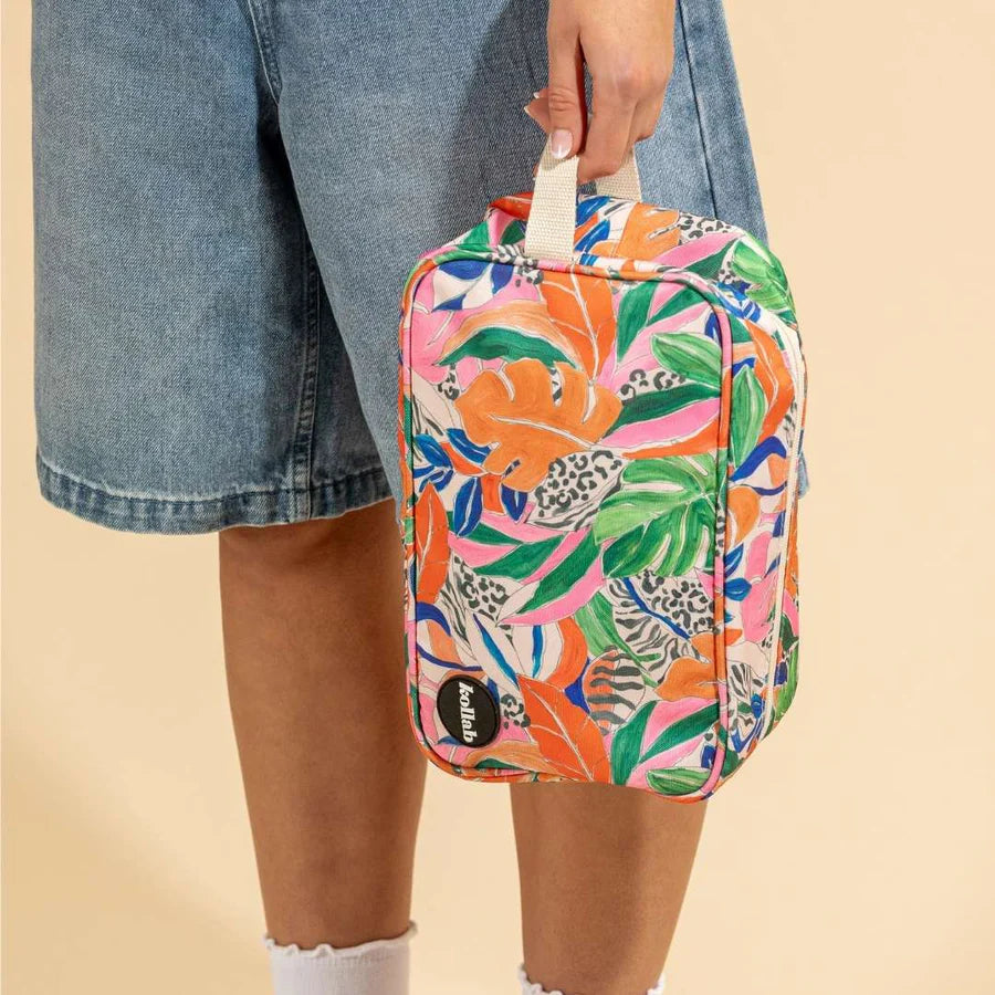 Lower half of girl holding colourful toilet bag