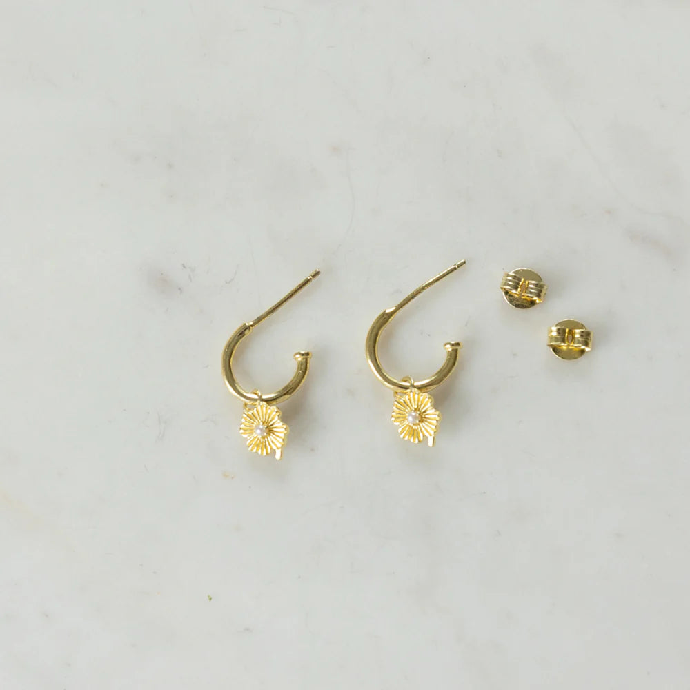 Gold small hoop earrings with a flower pendant and pearl centre