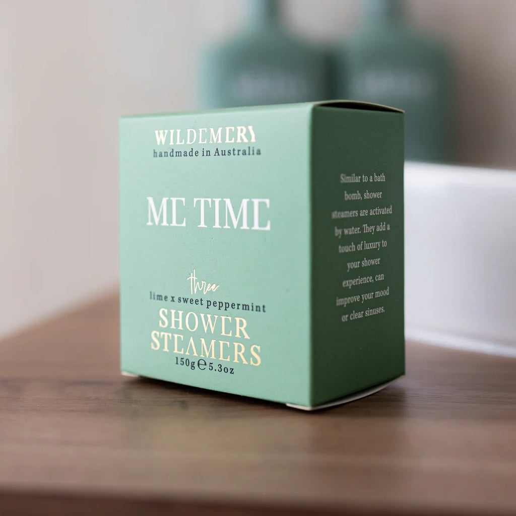 Angled turquoise shower steamer box in me time scent on a shelf