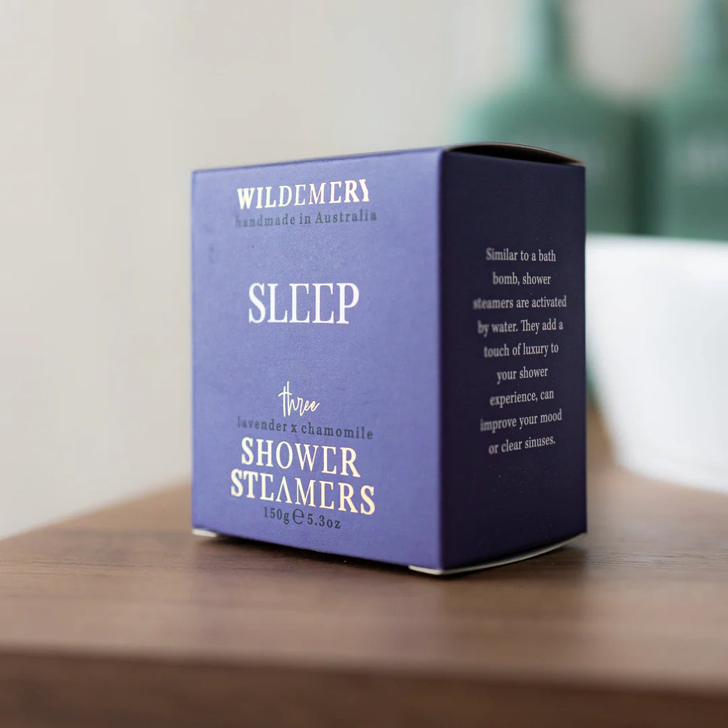 Angled purple shower steamer box in sleep scent on a shelf